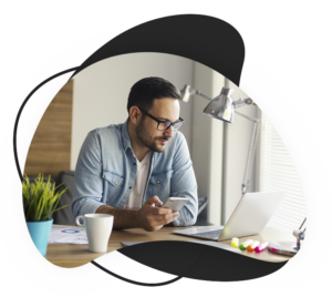 MAN AT DESK LOOKING AT MONITOR